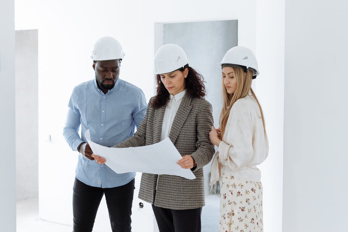 A team in hard hats reviewing plans inside a building
