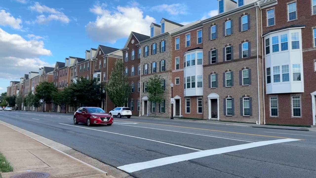 A row of brick townhomes along a residential street